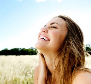A women smiling and enjoying the outdoors