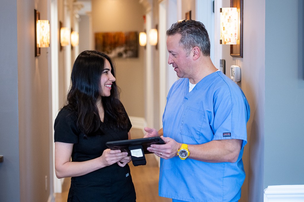 Dr. Mascia speaking with one of his office staff