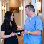 Dr. Mascia speaking with one of his office staff